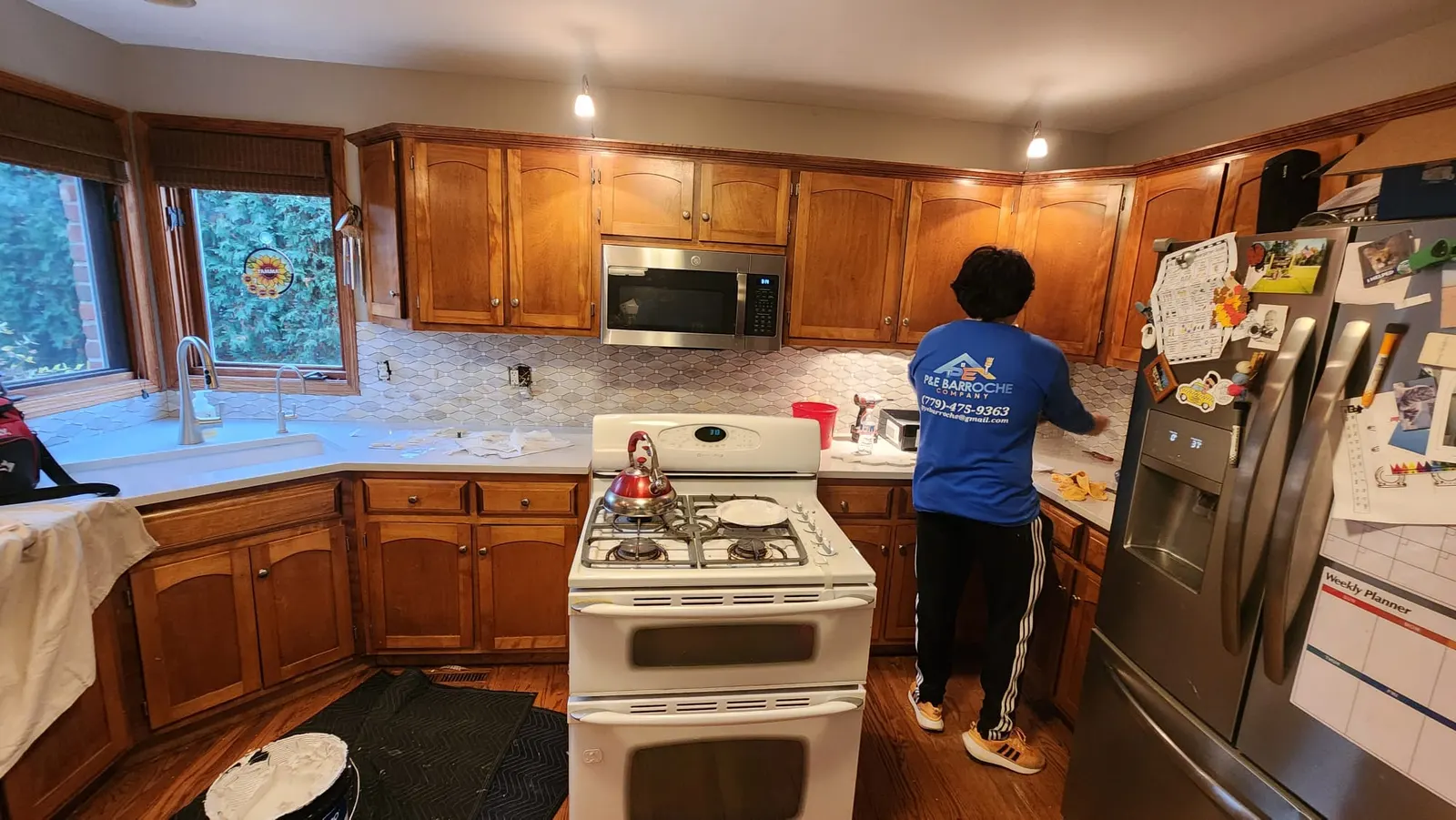 P&E Barroche Company crew member installing kitchen backsplash tile